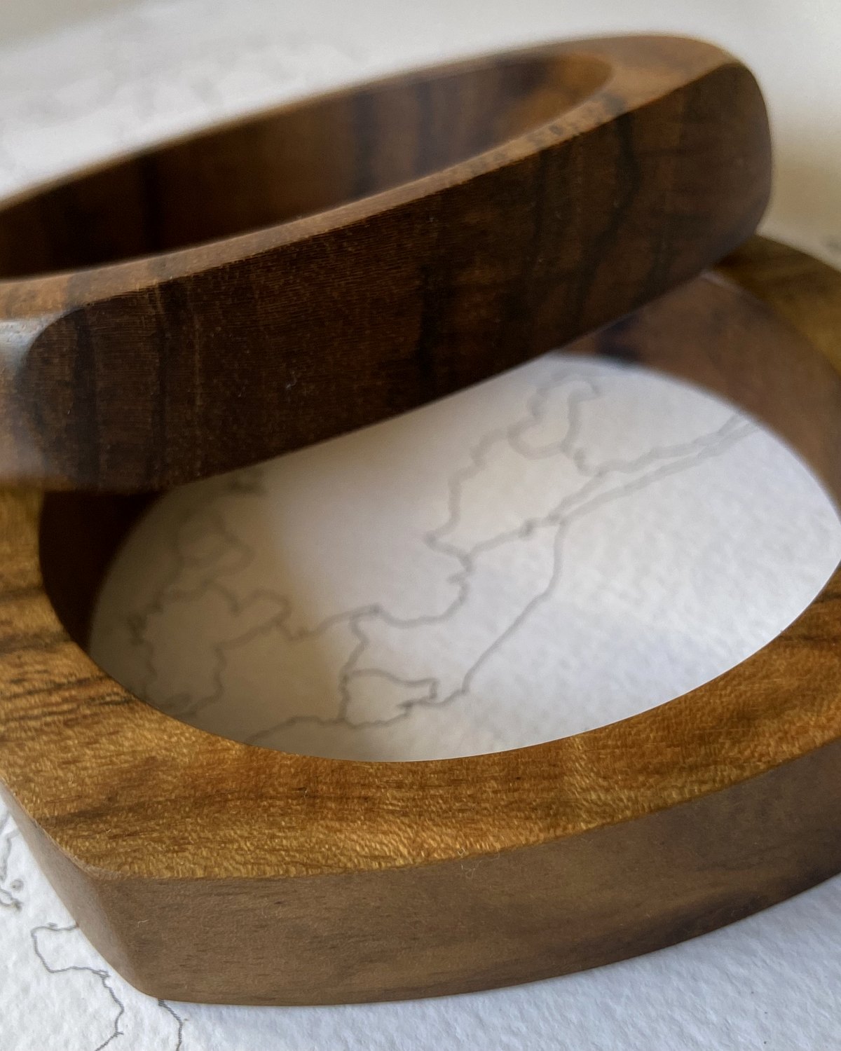 The Sigiriya Bangle — a hand-carved teak bangle with a teardrop profile