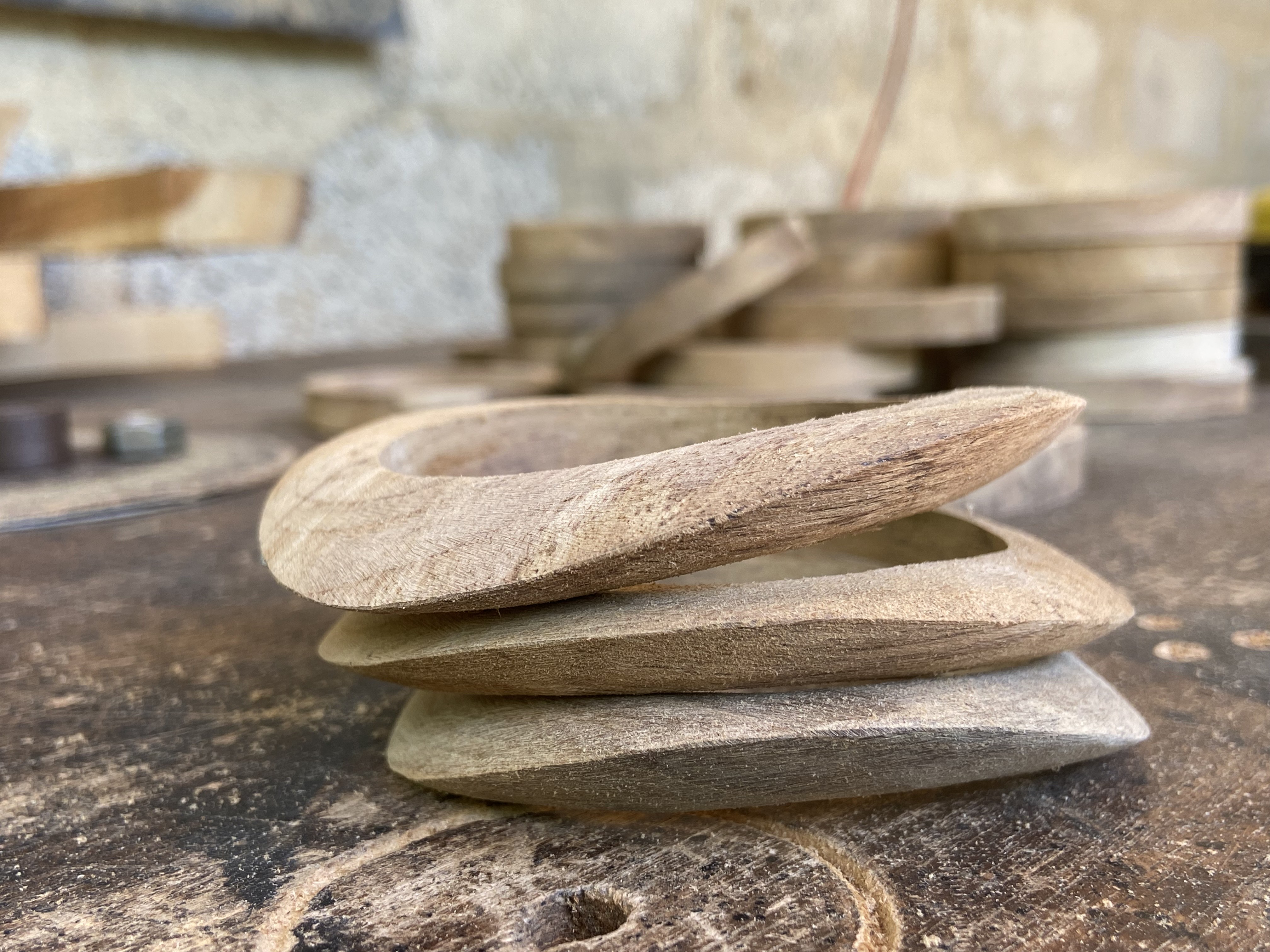 Stacked wooden forms showing smooth curved edges and layered colour