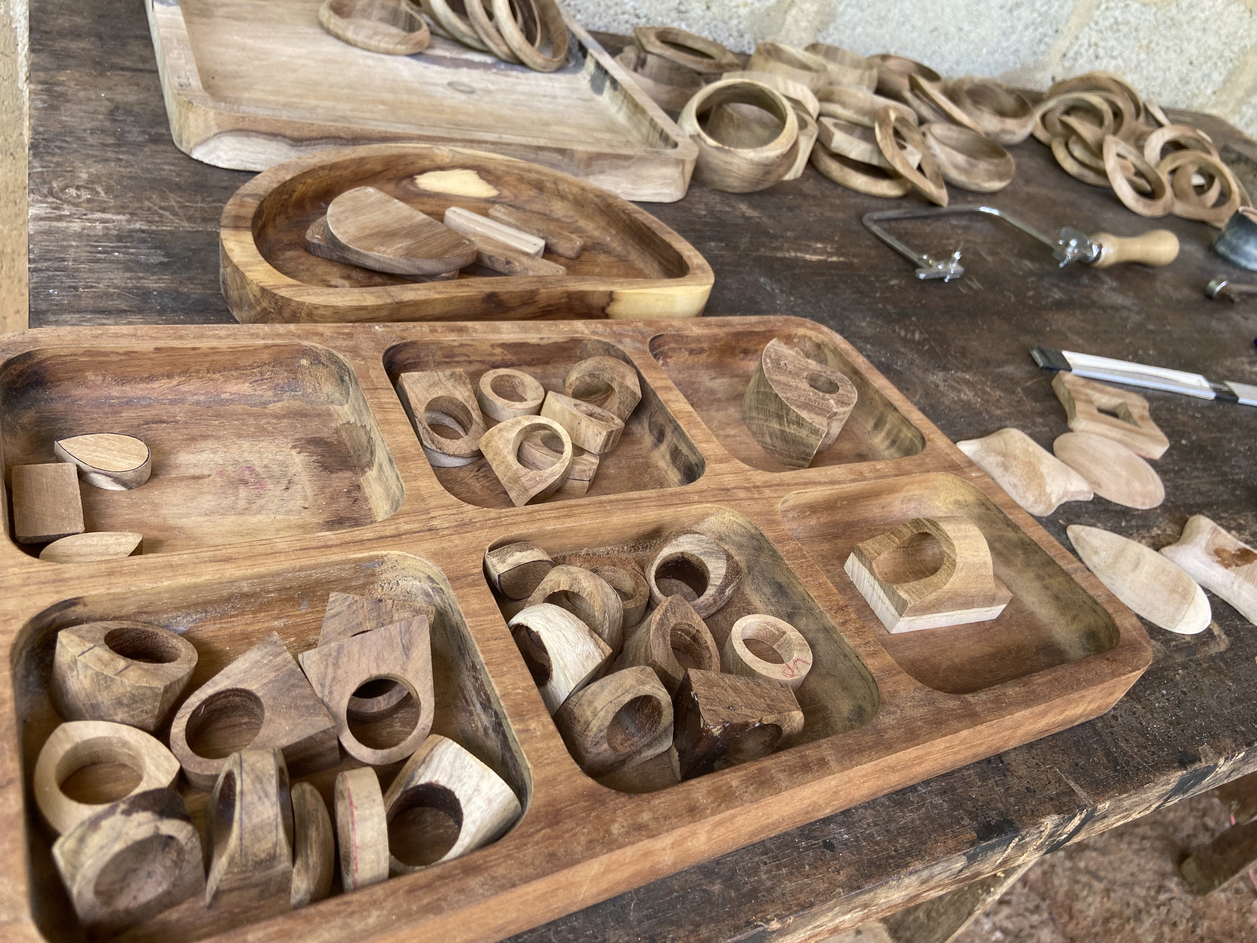 Close detail of carved wood forms, dusted with fresh sawdust